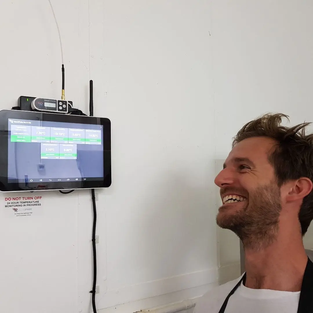 A SmartProbe display tablet installed on a kitchen wall